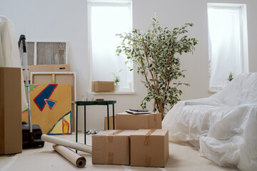 Moving in out, cardboard boxes with packed things, renting selling an apartment, changing location,...