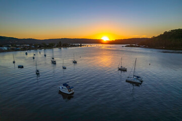 Aerial sunrise waterscape with boats and clear skies