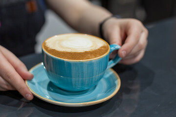 person holding coffee cup