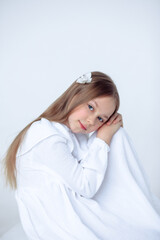 A beautiful cheerful little girl about 10 years old in a beautiful dress on an isolated white background.A place for your text.