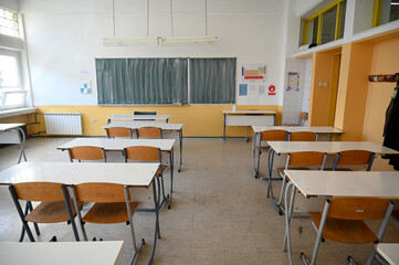 Classroom with blackboard for studying lessons. Empty classroom in elementary school. Rows of chairs and tables in classroom in high school. Lecture room. Education.