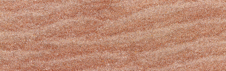 Coral pink sand beach texture background. Wide panorama pink sand banner
