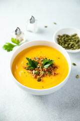 Traditional pumpkin soup with seeds and parsley