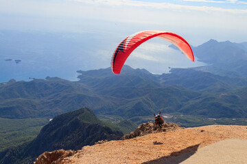 Paragliders flying from a top of Tahtali mountain near Kemer, Antalya Province in Turkey. Concept of active lifestyle and extreme sport adventure