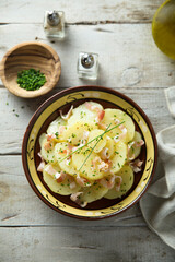 Homemade potato salad with bacon and chives