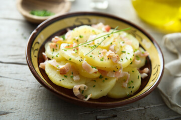 Homemade potato salad with bacon and chives