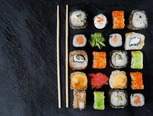 Mix of Japanese rolls in on a black background
