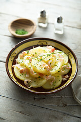 Homemade potato salad with bacon and chives