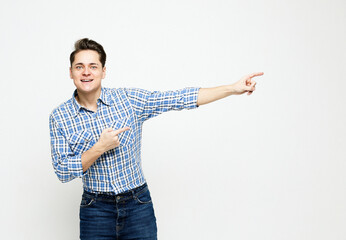 amazed cheerful guy demonstrating ad offer bargain isolated over white background