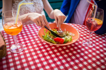 drinks and food on the table with the hands of lovers