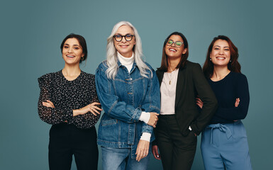 Multicultural group of women smiling at the camera with confidence