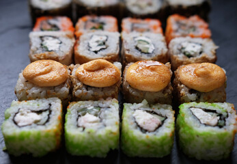 Japanese sushi food. Maki ands rolls with tuna, salmon, shrimp, crab and avocado. Top view of assorted sushi.