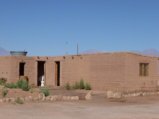 Photograph taken on a sunny day around Atacama desert region at Chili, showing the architecture and colours of this historical place. Rocks formation, lagoons, fauna and geysers.