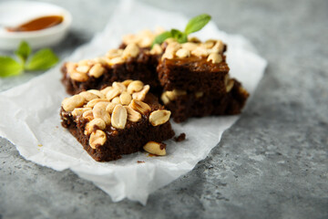 Traditional homemade brownies with caramel and peanut