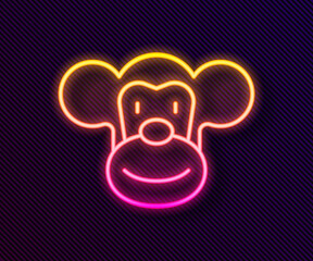 Glowing neon line Monkey icon isolated on black background. Animal symbol. Vector