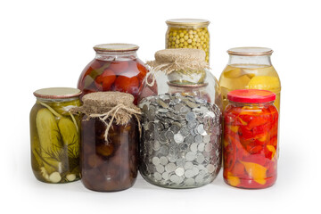 Big jar with coins among home canned fruits and vegetables