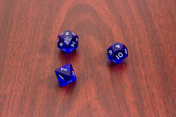 Specialized polyhedral dice for role-playing games on red wooden table