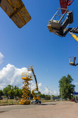 Articulated boom lift, scissor lift, other lifts buckets on foreground © An-T