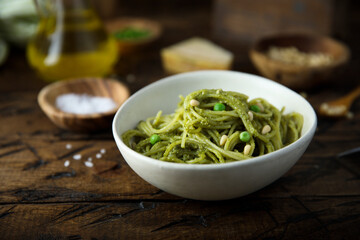 Spaghetti with pesto sauce and green pea