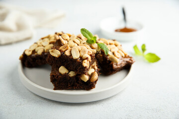 Traditional homemade brownies with caramel and peanut