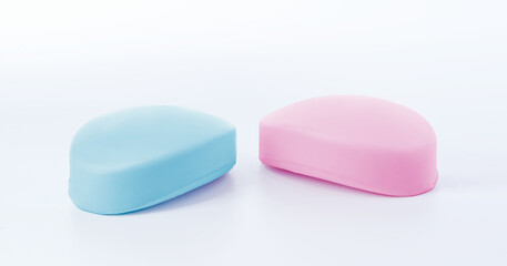 Pink and blue soap bars on white background