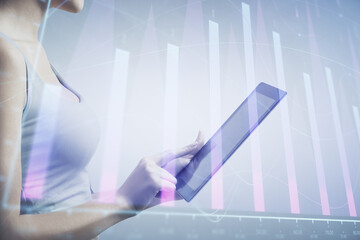 Double exposure of forex chart sketch hologram and woman holding and using a mobile device....