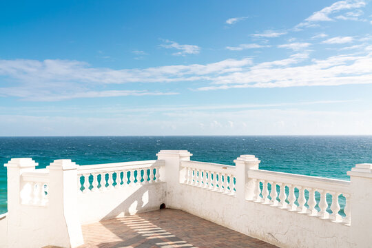 Isolated balcony mirador painted in white. Situated in Nerja city on Carabeo street is a famous location.  Under this balcony is a small and isolated beach maned "Carabeo Playa".