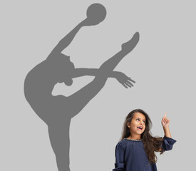 Little cute girl dreaming about future of famous sport athleet