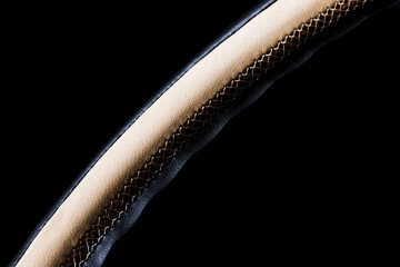 Close-up of a luxury expensive steering wheel trim in black and light leather.