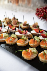 on a wooden table in the wedding banquet area are snacks, fruits, sweet cakes and muffins and lemonade drink