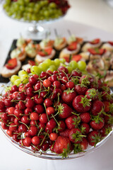 on a wooden table in the wedding banquet area are snacks, fruits, sweet cakes and muffins and lemonade drink