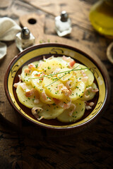 Homemade potato salad with bacon and chives