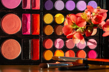 Eye shadows palette and brushes. Makeup moody background.