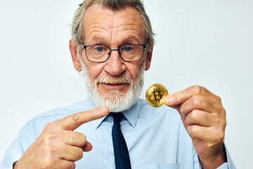 Portrait elderly man Bitcoin cryptocurrency in the hands of a financier isolated background
