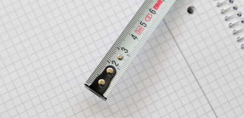 a white measuring tape on a piece of paper