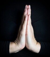 praying hands on black background