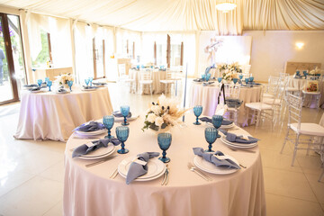 banquet table is decorated with plates, cutlery, glasses, candles and flower arrangements
