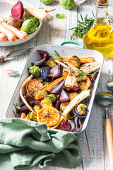 Mixed root vegetable roast with herbs. Healthy simple grill food