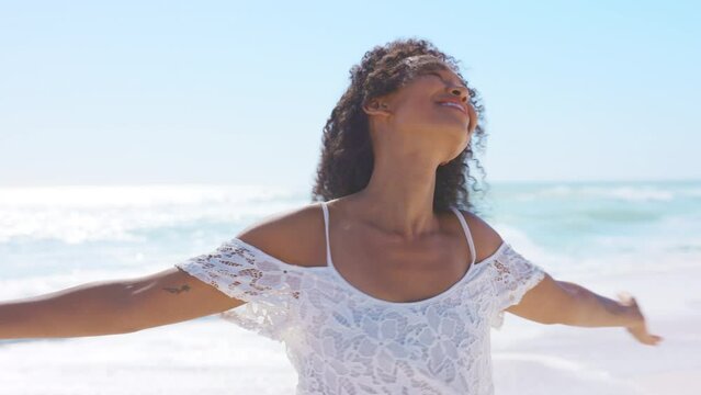 Carefree Smiling Black Woman At Beach Outstretching Arms