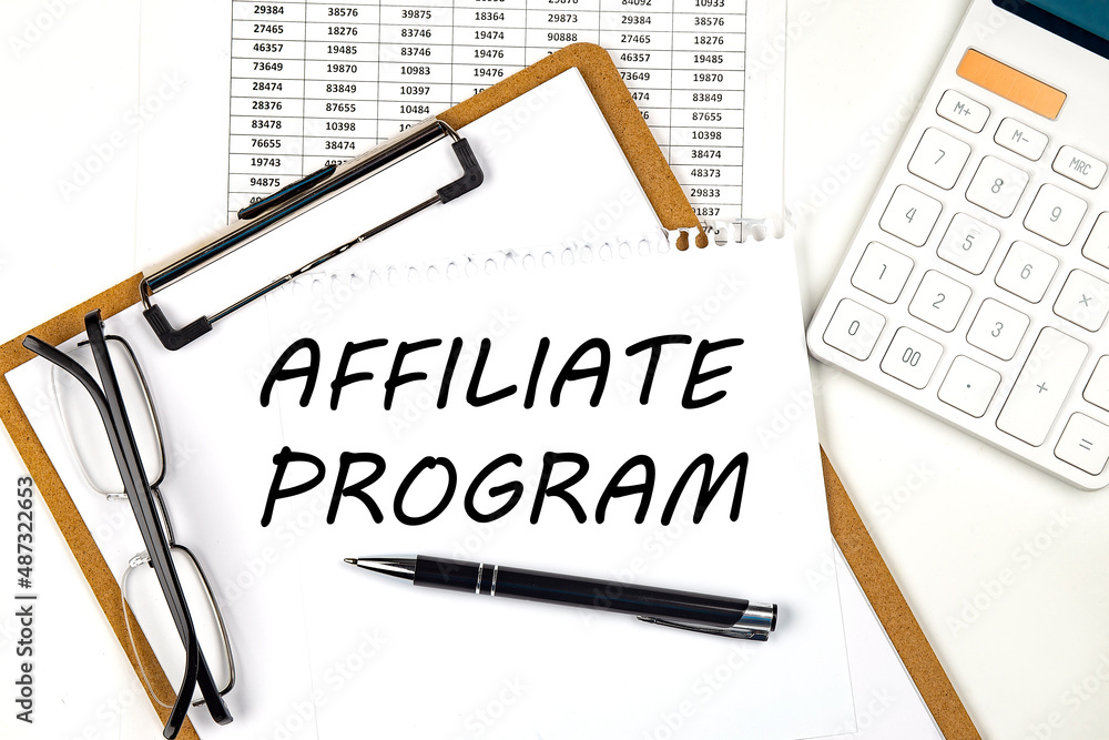 Poster text affiliate program on the white paper on clipboard with chart and calculator