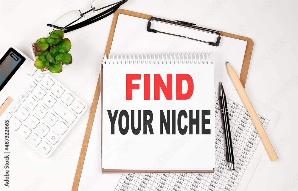 Aufkleber office desk table with paper sheet, notepad ,chart and calculator. top view, text find your niche