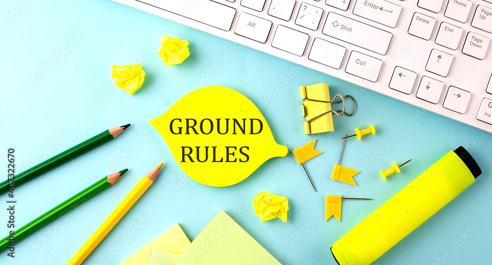Aufkleber text sign showing ground rules with office tools and keyboard on the blue background