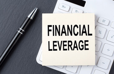 Text FINANCIAL LEVERAGE on sticker on calculator, business concept