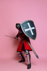 Portrait of medieval warrior or knight wearing armor clothing holding shield and sword isolated...