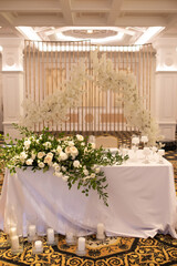 banquet table is decorated with plates, cutlery, glasses, candles and flower arrangements