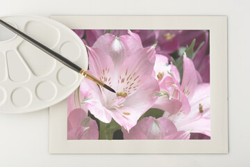 brush for painting with paints and palette, photography of flowers in a white frame