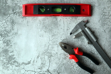 A set of tools on a gray background. Top view.