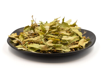 Winter herbal tea on a white background. Winter tea. Medicinal tea prepared from linden leaves, Clove particles and Chamomile