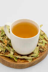 Winter Herbal tea isolated on a white background. Linden tea. immune-boosting herbal tea. Medicinal tea prepared from linden leaves, Clove particles and Chamomile.