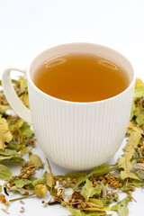 Winter Herbal tea isolated on a white background. Linden tea. immune-boosting herbal tea. Medicinal tea prepared from linden leaves, Clove particles and Chamomile.